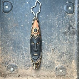 Hand Carved Wooden Mask.  Origin Unknown.  It’s 12” x 3” without the beads.